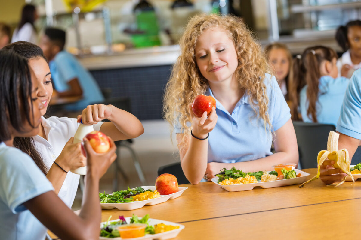Teen girls eating in the school canteen