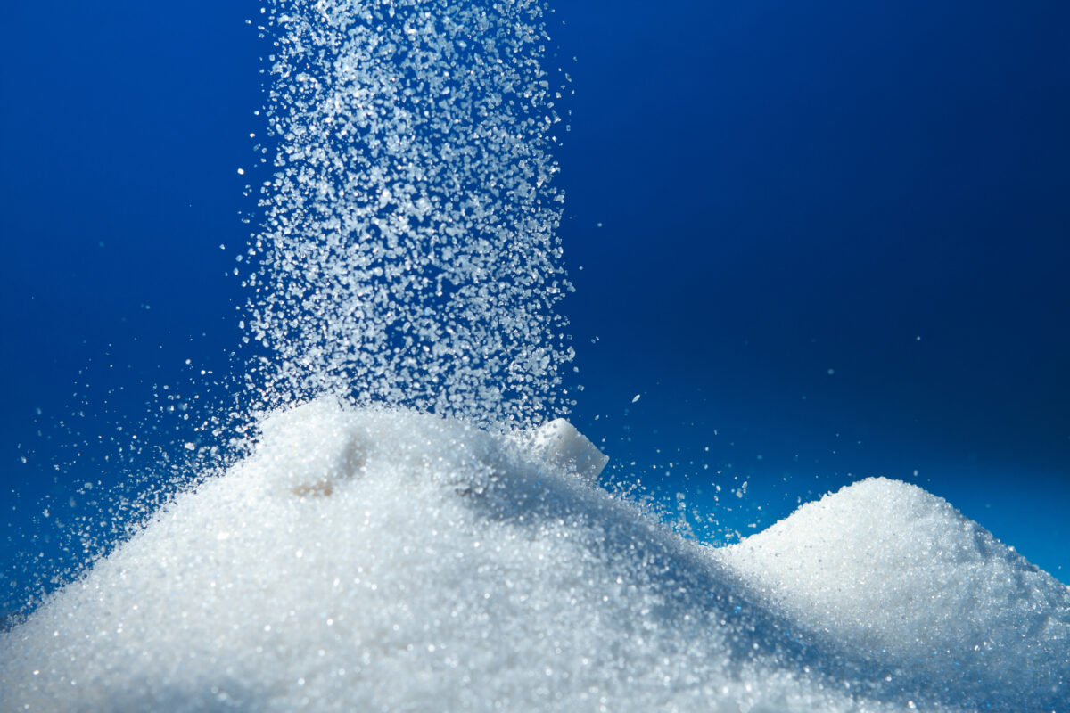 piles of sugar on blue background