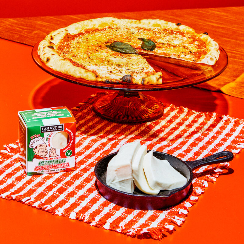 Mozzarella cheese and pizza on red background