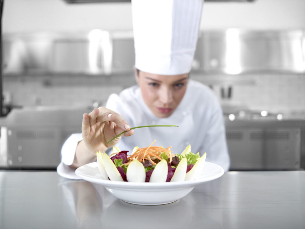 Chef preparing salad in kitchen