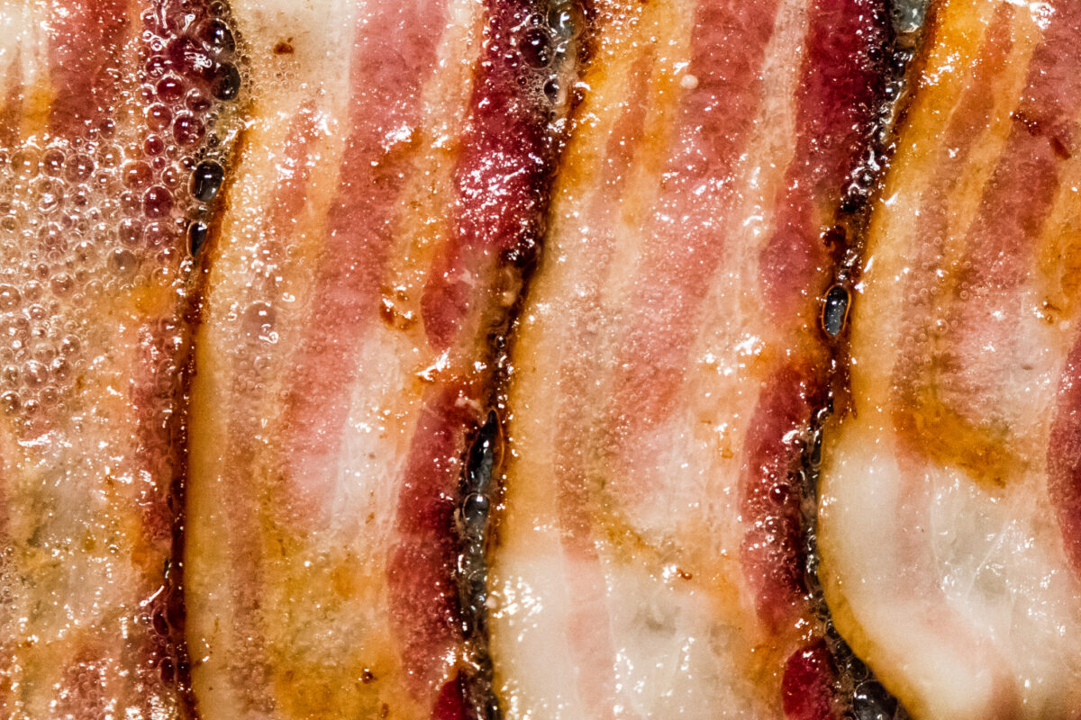 close up of bacon frying