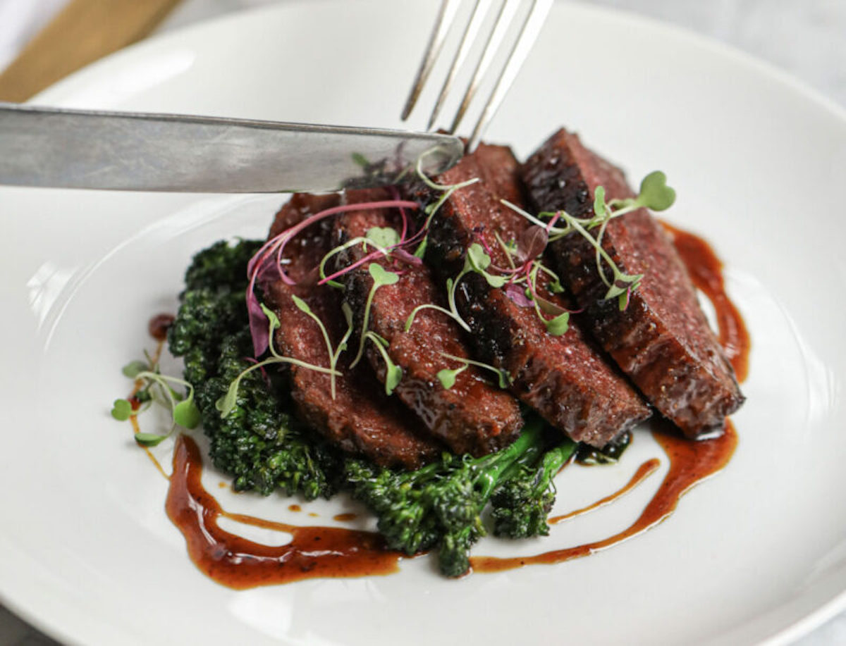 plant-based steak on a plate with garnish