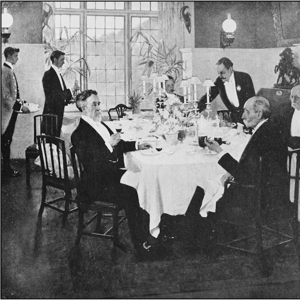 Black and white image of upper classes being served dinner in a restaurant