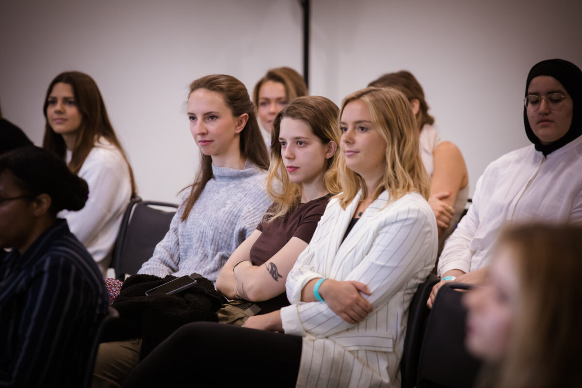 group of female students sat watching panel talk