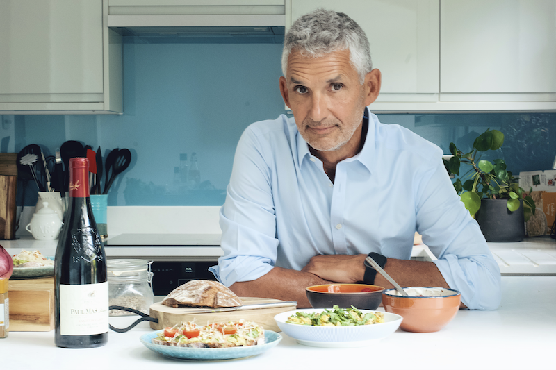 Tim Spector sitting at a table with food in front of him
