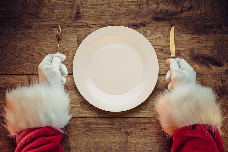 Santa Claus holding fork and knife