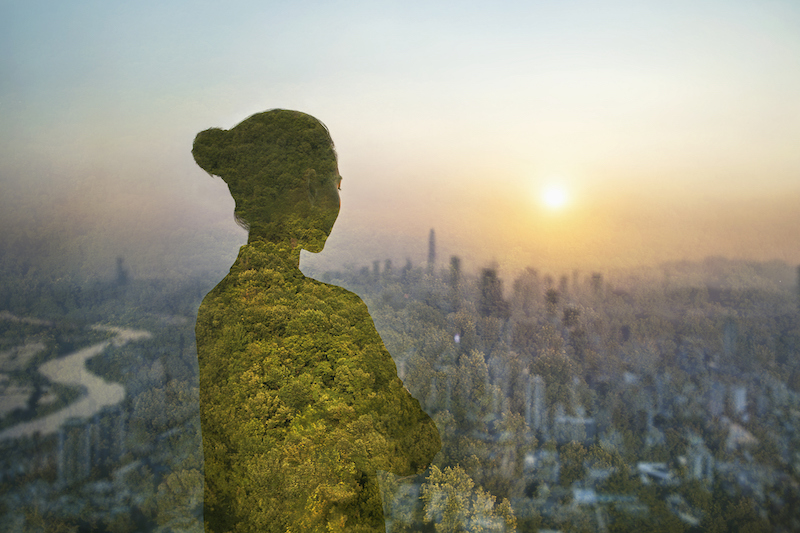 Person standing in contemplation in urban city with nature trees composite