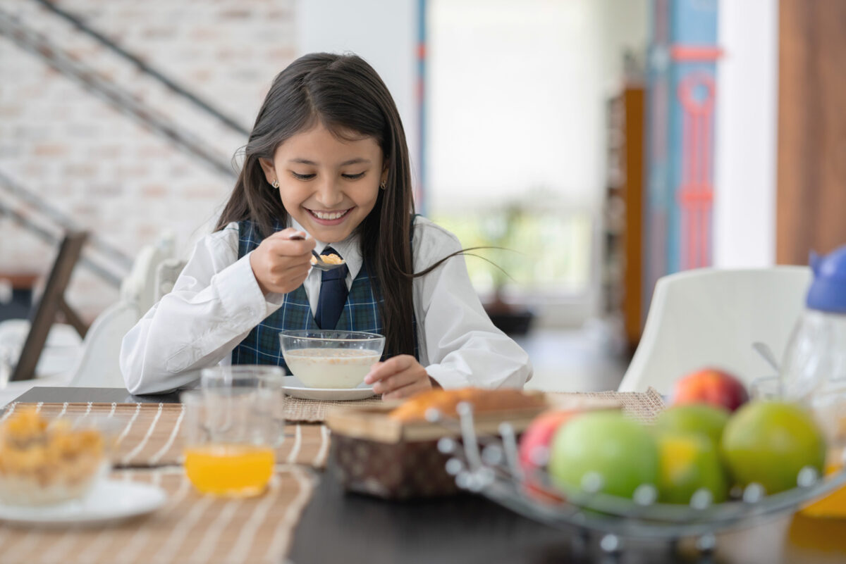 schoolgirl eating breakfast