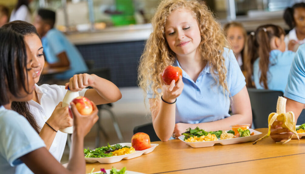 Teen girls eating in the school canteen