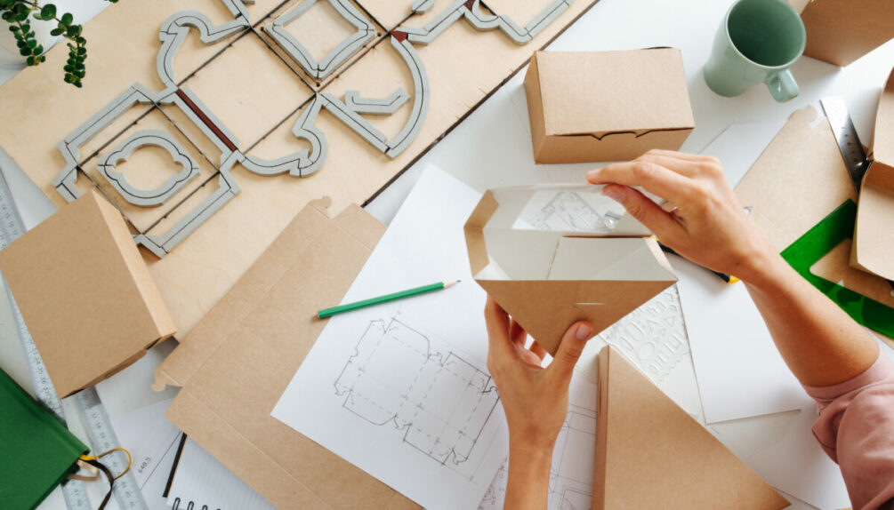 woman making cardboard container