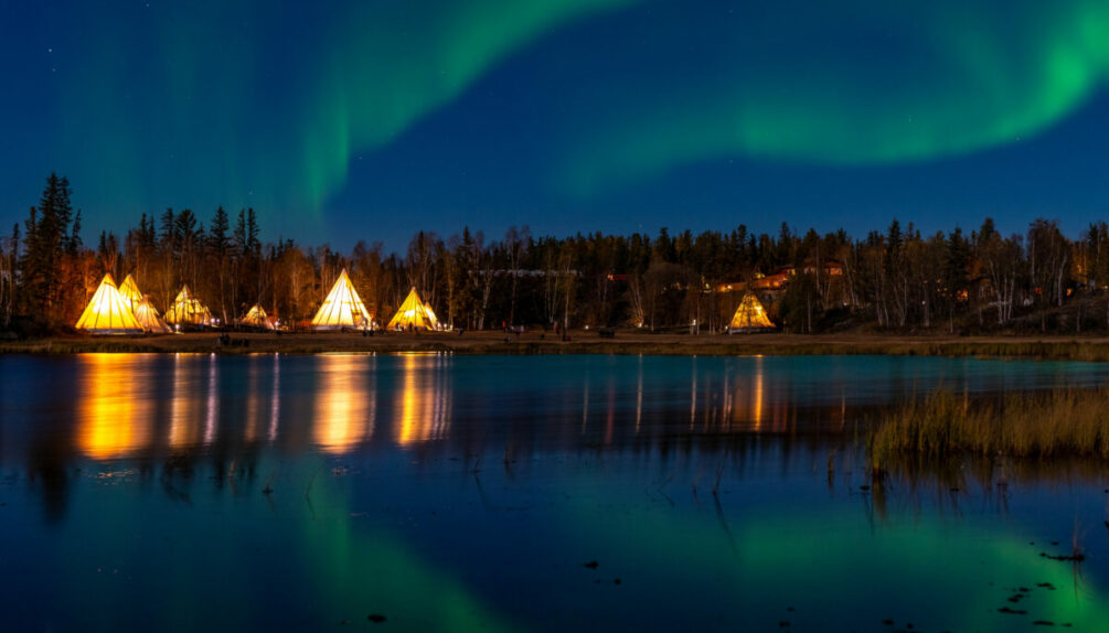 Light up Tipi (indian Tent) with water reflection during Aurora Borealis (Northern Light) at Yellow Knife,