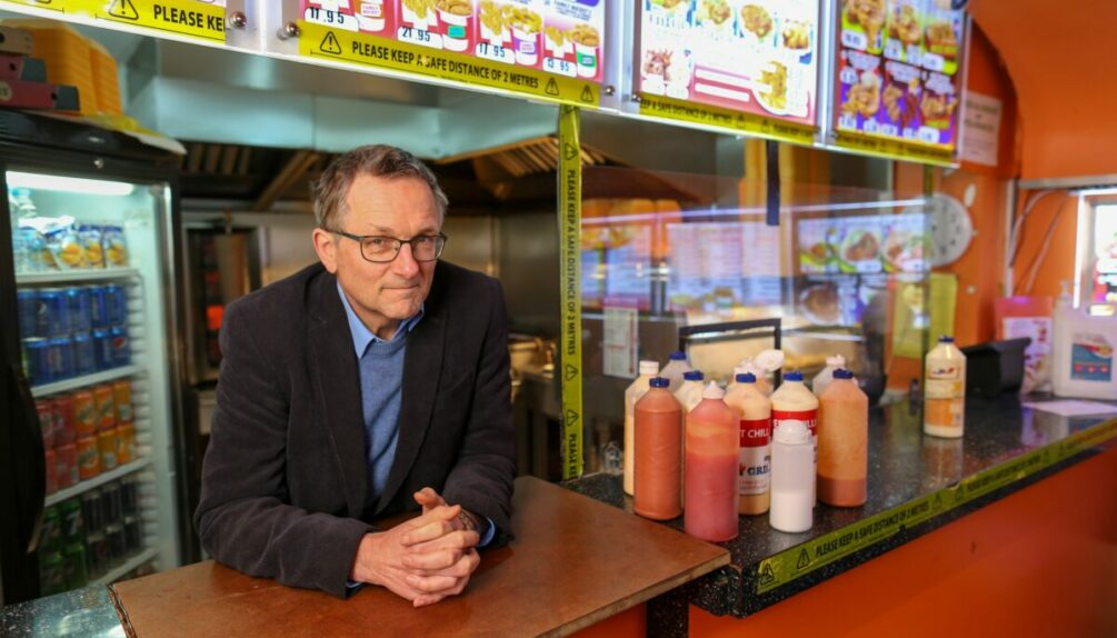 man with glasses in a chip shop