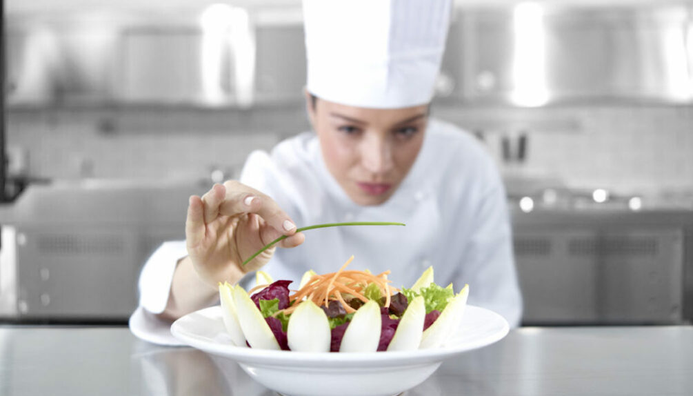 Chef preparing salad in kitchen