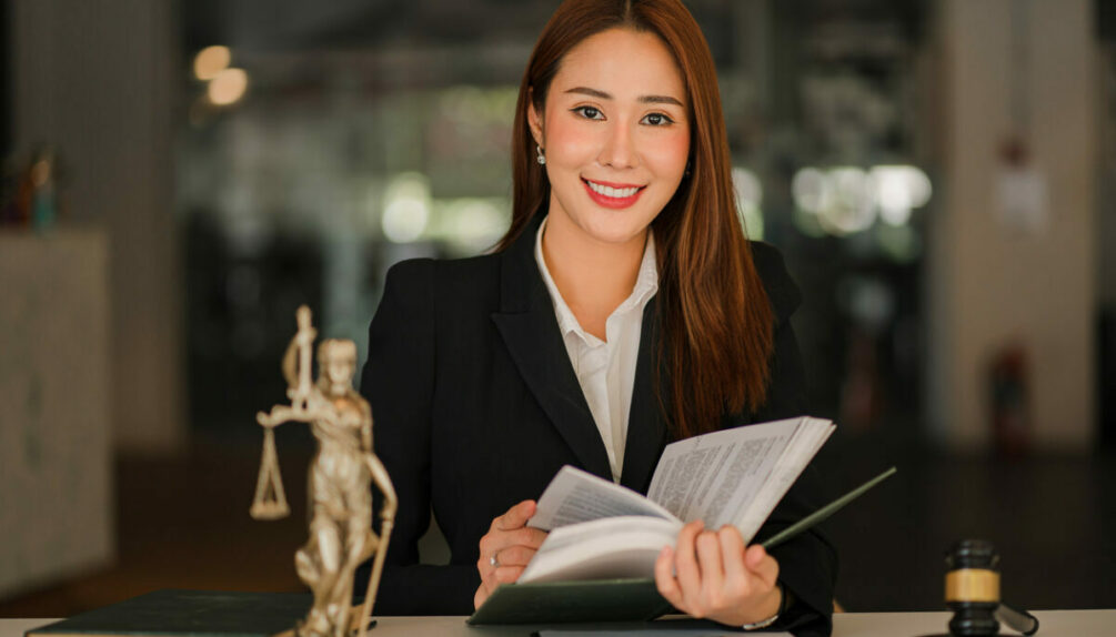 Lawyer sat at her desk consulting a book