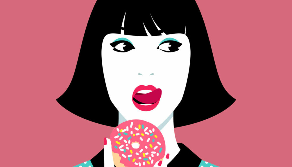 woman eating donut against pink background