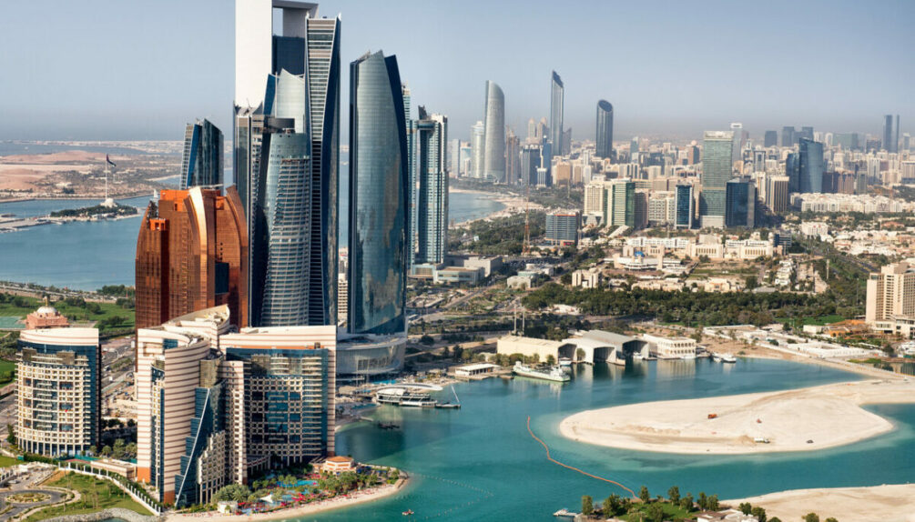 Part of Abu Dhabi, UAE with tall buildings and surrounding area viewed from the helicopter. Many details are visible in the image