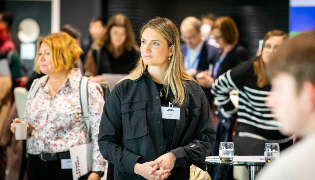 a woman staring, surrounded by people