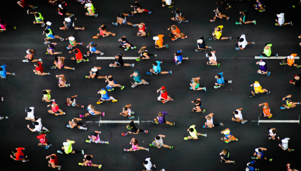 overhead shot of marathon runners on a concrete road