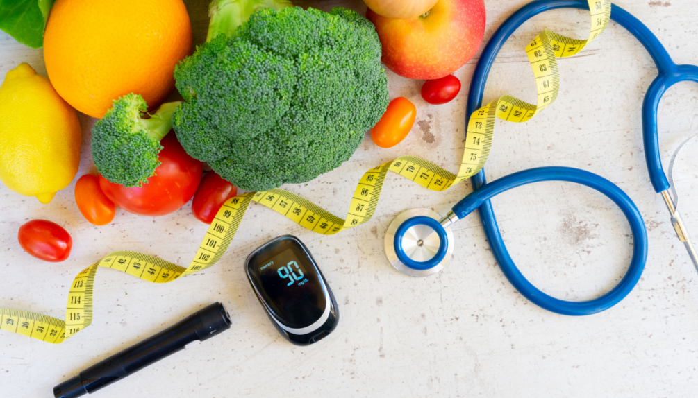 A tape measure, stethoscope and vegetables representing the link between disease and nutrition