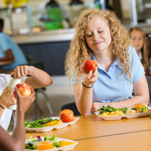Teen girls eating in the school canteen