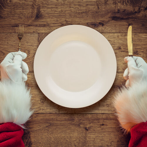 Santa Claus holding fork and knife