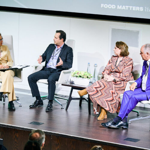 Three guests on stage with a host on the left, taking part in the The business case for sustainable food across the supply chain panel discussion