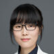 woman with glasses in a coat lab