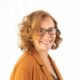 Woman with glasses smiling
